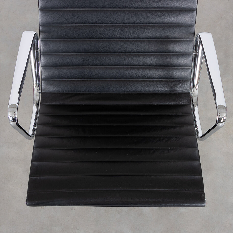 Eames EA124 lounge armchair black leather and chrome frame Vitra