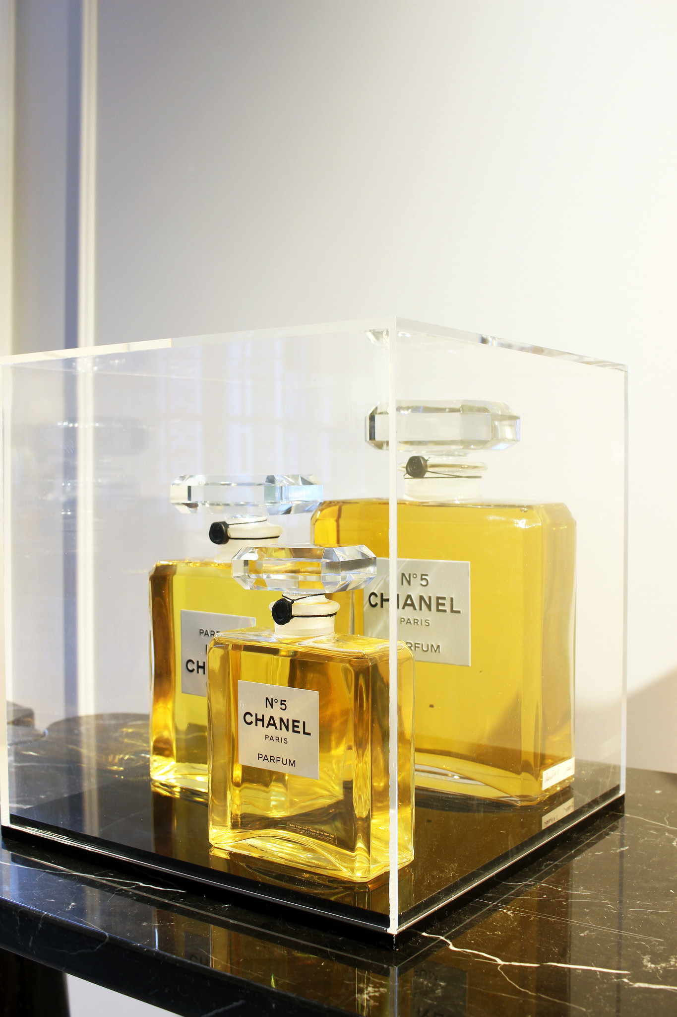 Large Chanel perfume bottles in display case