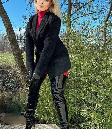 Jasmine in the Vegan Gigi thigh boots black shiny