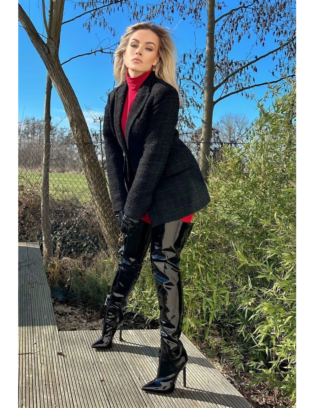 Jasmine in the Vegan Gigi thigh boots black shiny