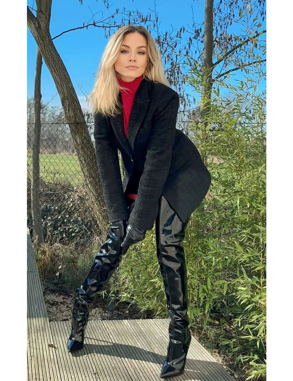 Jasmine in the Vegan Gigi thigh boots black shiny