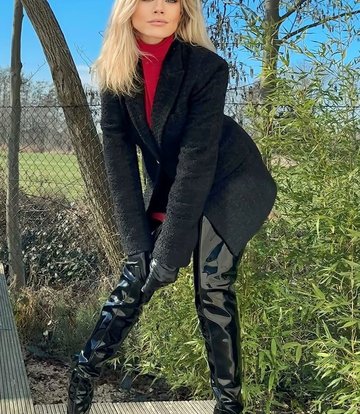 Jasmine in the Vegan Gigi thigh boots black shiny