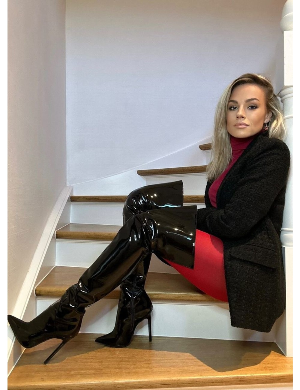 Jasmine in the Vegan Gigi thigh boots black shiny