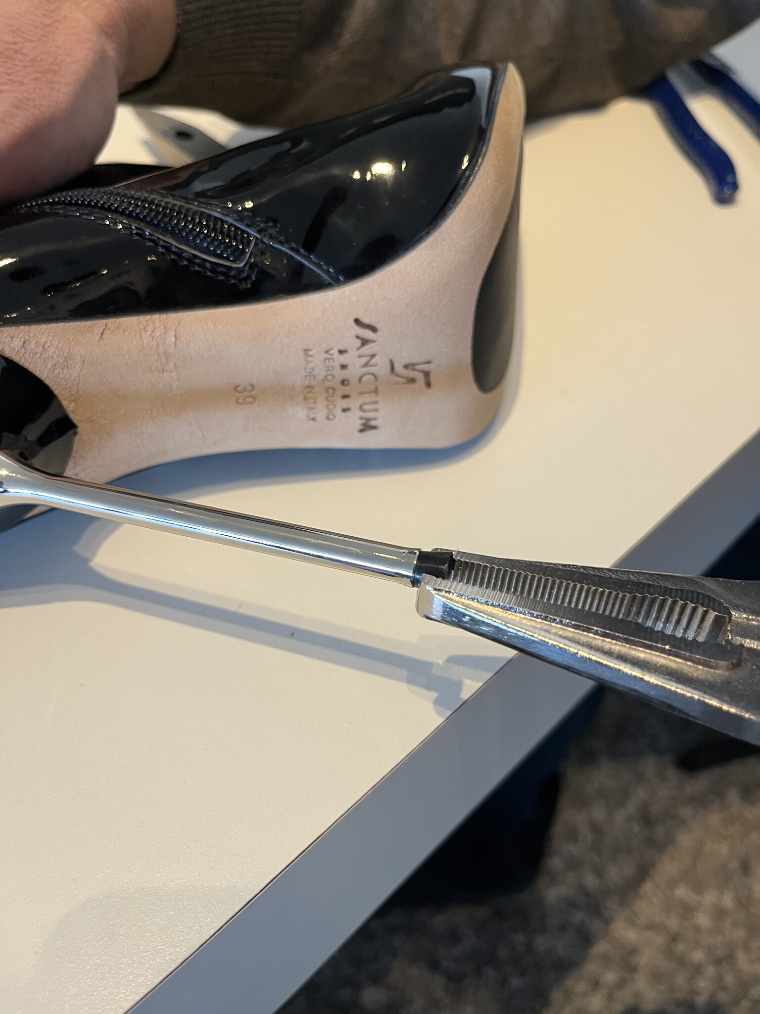 heels gripped by plier