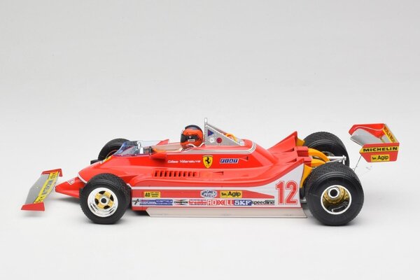 Formule 1 Ferrari F1 312T4 #12 Winner GP Watkins Glen USA (G.Villeneuve)) + Pilot Figure + Rain Wheels  -1:18 - Bburago