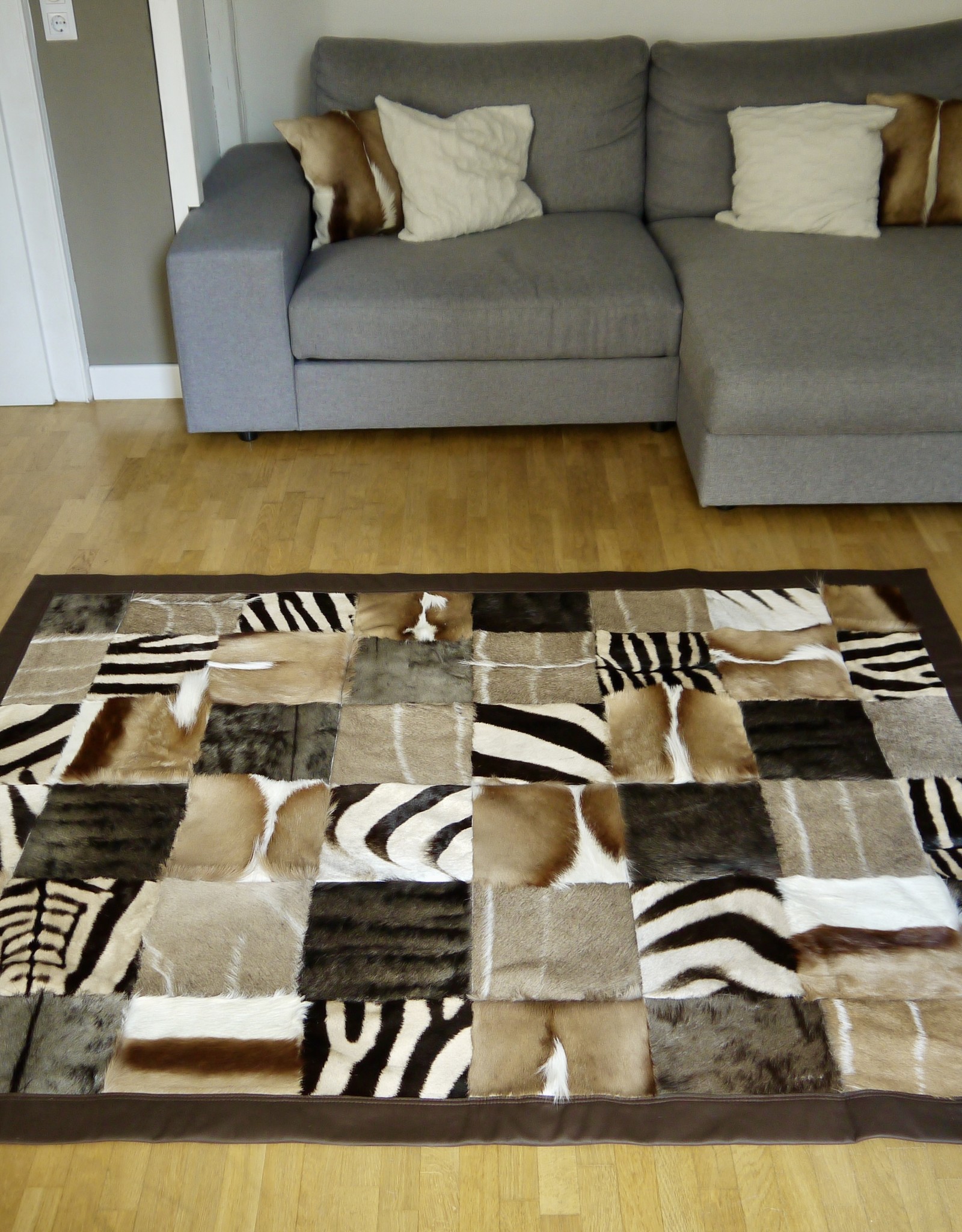 Fur rug made from genuine African wild animal skins - with leather edging