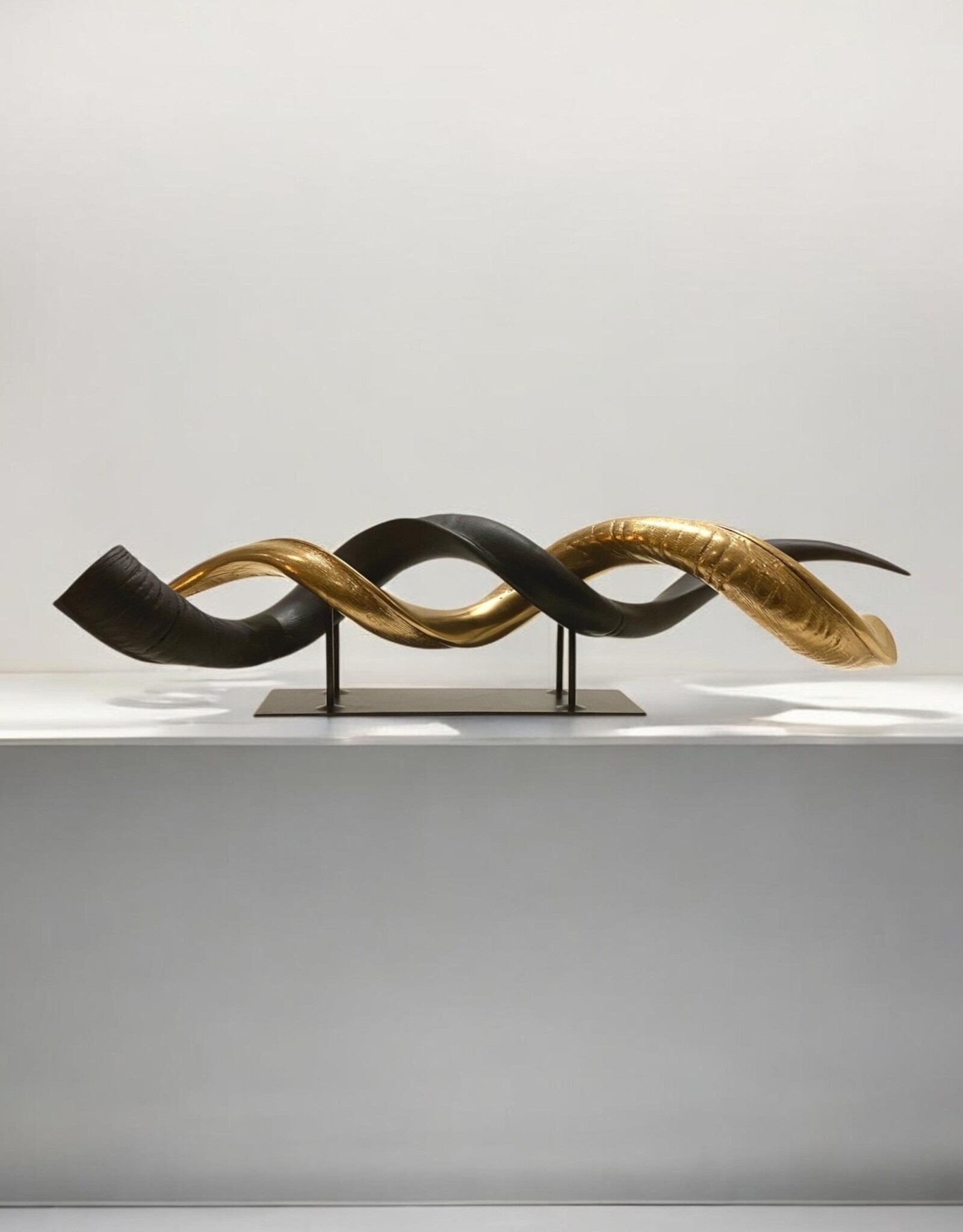 Kudu horn partly ground double on metal stand in gold matt black
