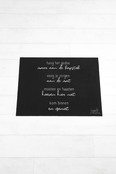 Deurmat zwart met gedicht 'Kom binnen en geniet'