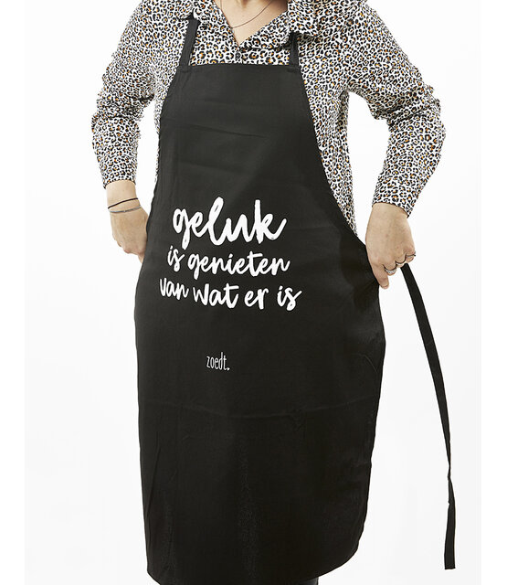 Schort met tekst 'Geluk is genieten van wat er is' in cadeauverpakking