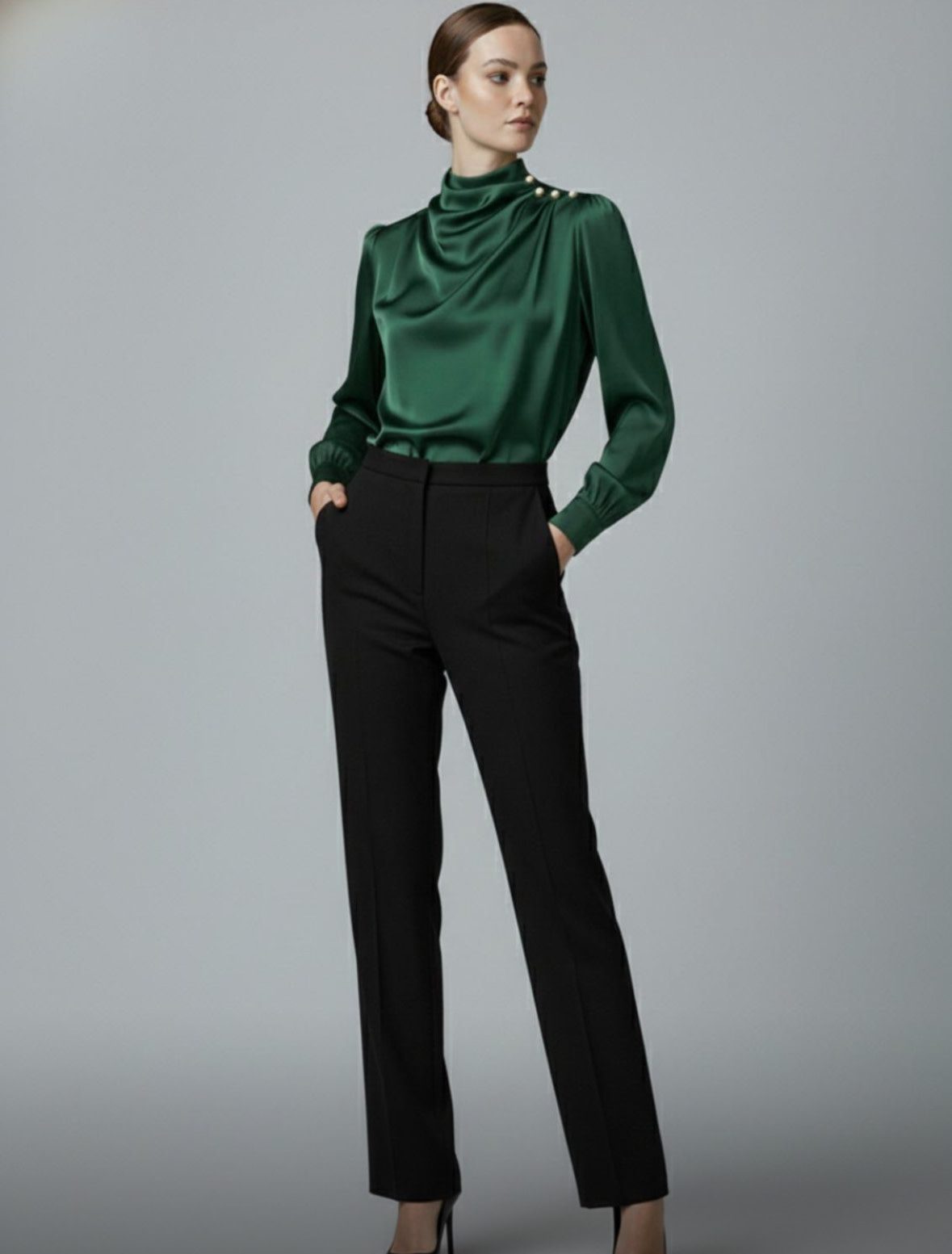 Woman wearing emerald green blouse with black pants for evening