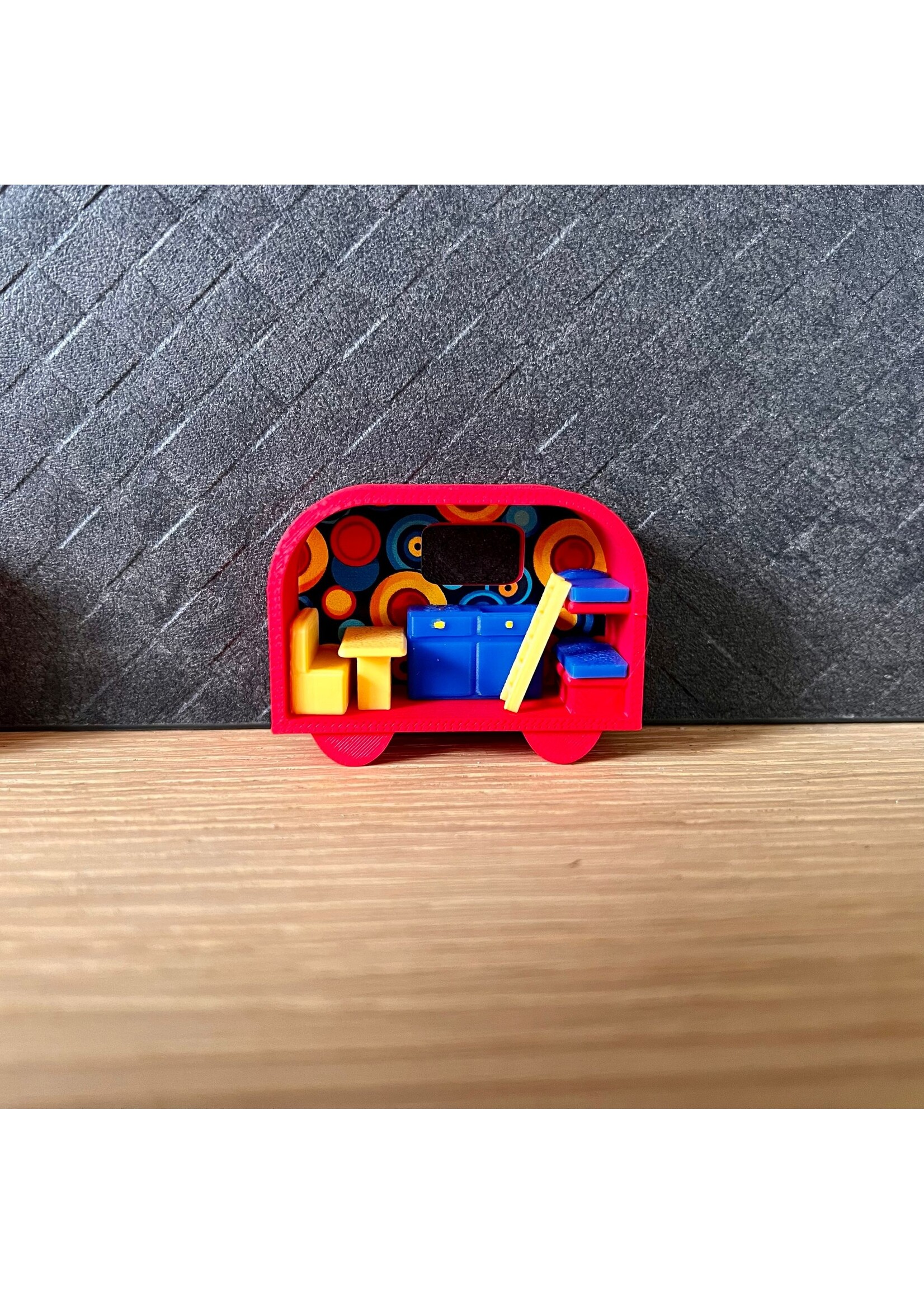 Miniatuur caravan in rood, geel en blauw