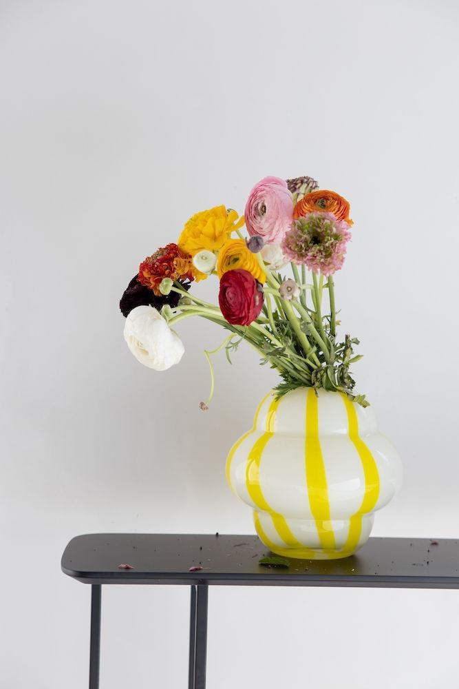 Gusta Vase Curlie 2. This vase is made of glass with rounded shapes and hand-painted stripes to brighten up the room. The...