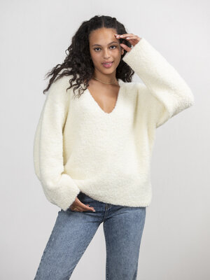 Knitted jumper Quence. This V-neck knitted sweater, crafted in a bouclé texture, offers ultimate comfort. With dropped sh...