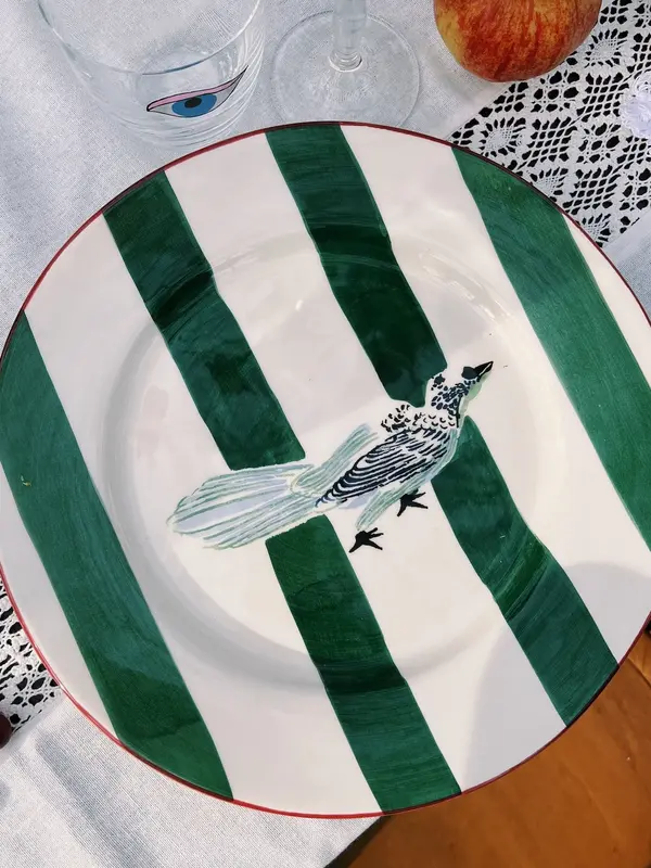 Anna + Nina Dinner Plate Lovebird 2. This ceramic dinner plate with green stripes and a hand-painted bird design is the p...