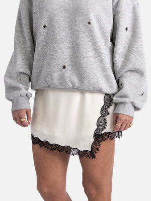 Skirt Edie. Create stylish contrasts with this white lace skirt and the enveloping black lace border, making it not only ...