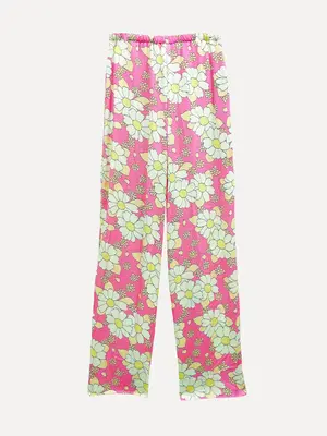 Pantalon Shaning. Créez un look joyeux et dynamique avec ce pantalon imprimé de fleurs, parfait pour les journées plus ch...