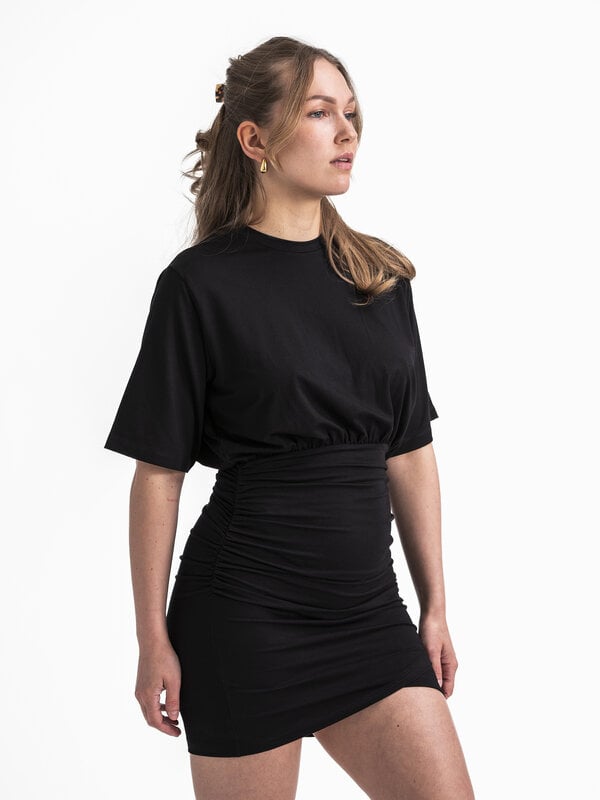 Edited Dress Thivya 3. This black dress, made from t-shirt fabric, combines comfortable elegance with a fitted skirt that...