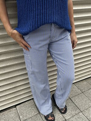 Striped trousers. Make a statement with these striped pants in light blue and white, complete with cargo pockets for a tr...