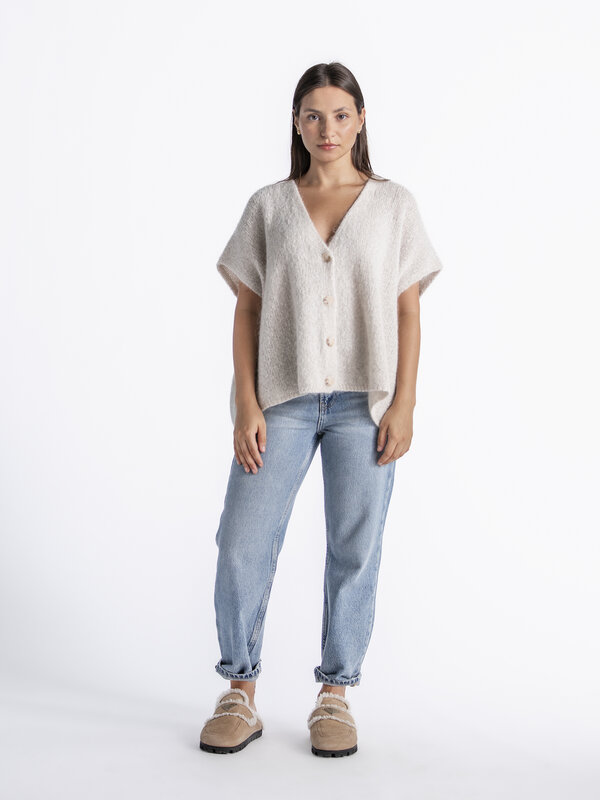 Le Marais Sleeveless knitted vest Live 1. Off-white, the color of infinite styling options. This cardigan not only goes w...