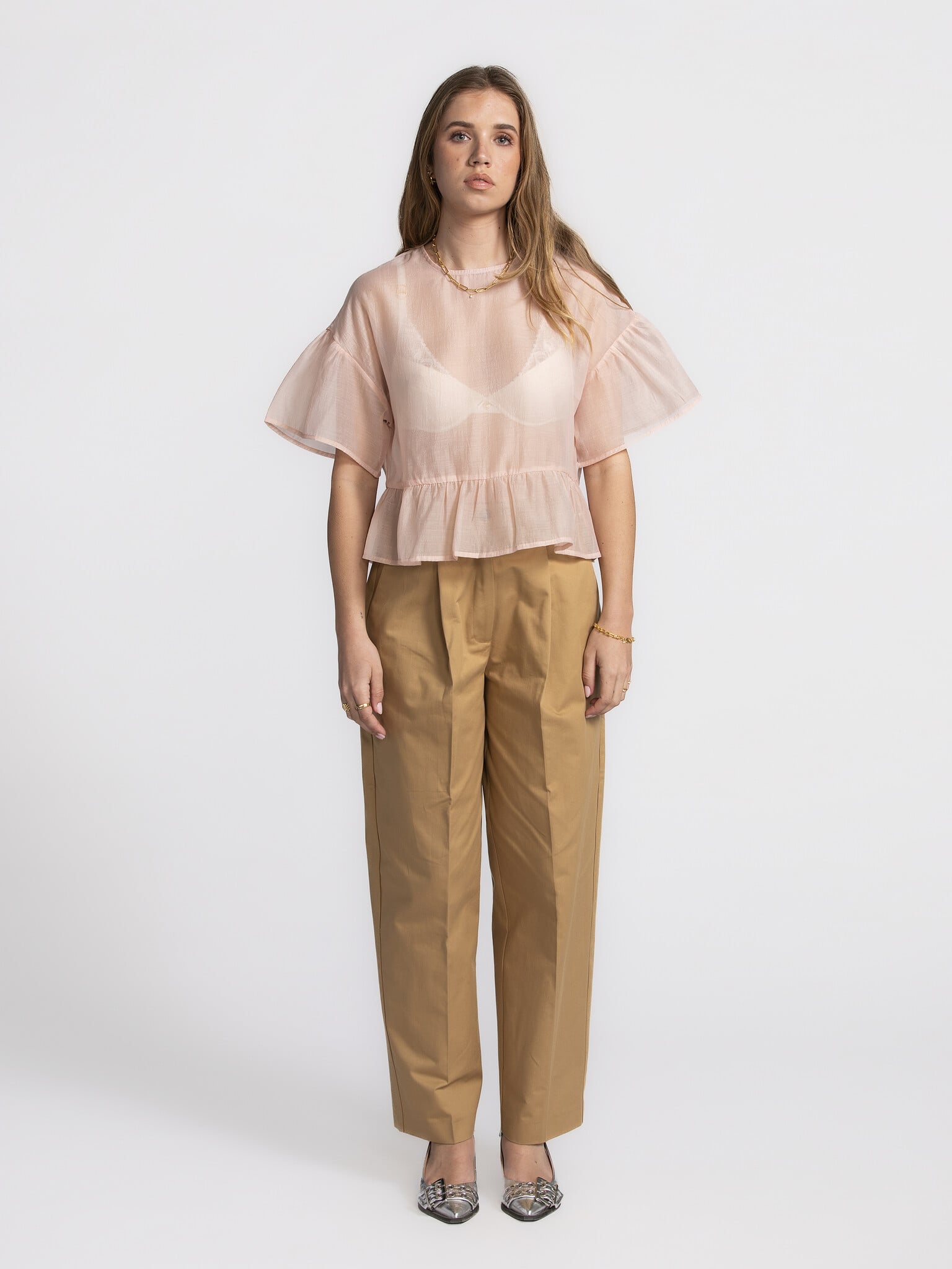 Edited Ruffled blouse Tuala 1. Blushing beauty! This delicate soft pink top brings a romantic touch to your wardrobe. The...