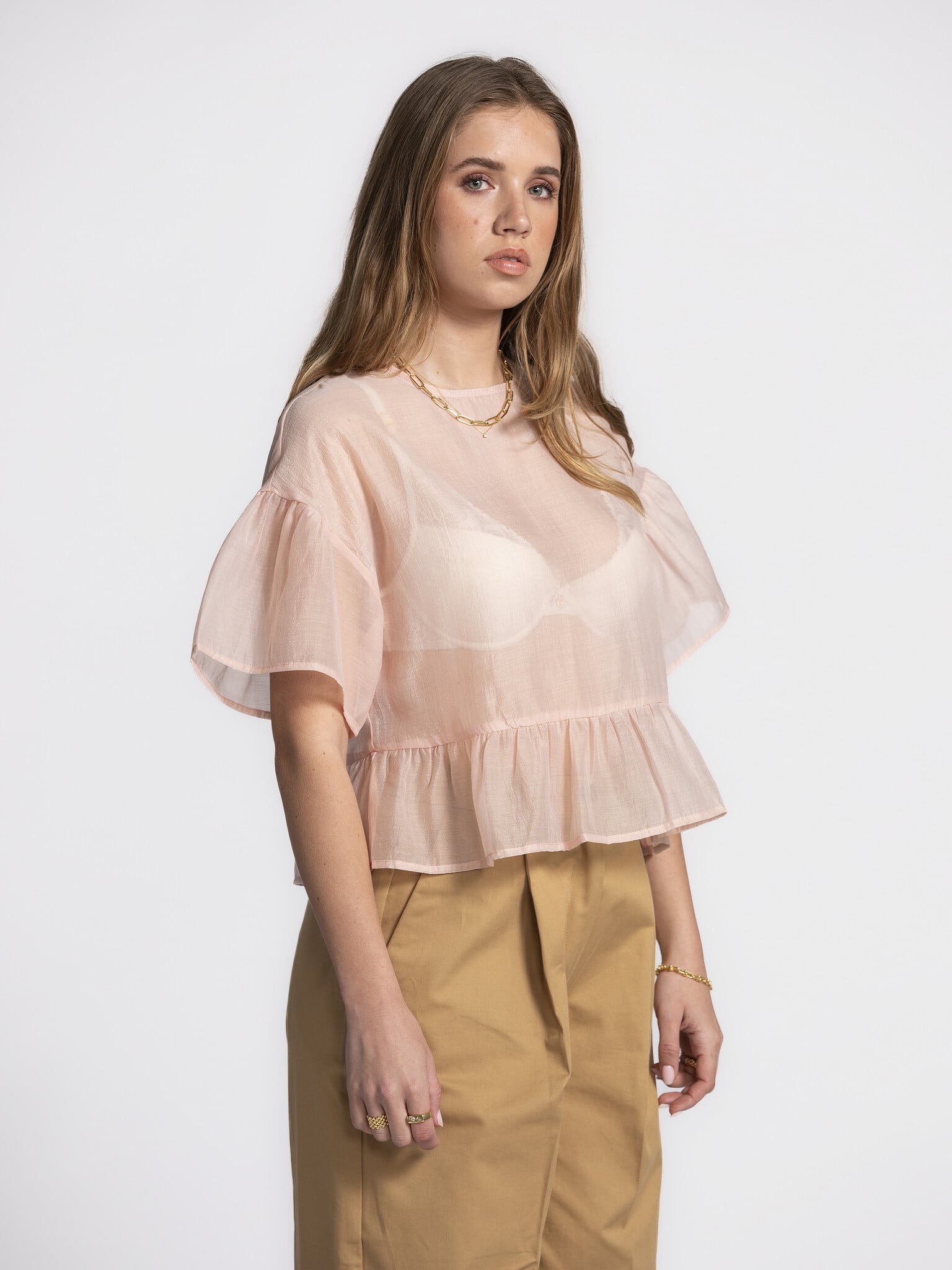 Edited Ruffled blouse Tuala 3. Blushing beauty! This delicate soft pink top brings a romantic touch to your wardrobe. The...