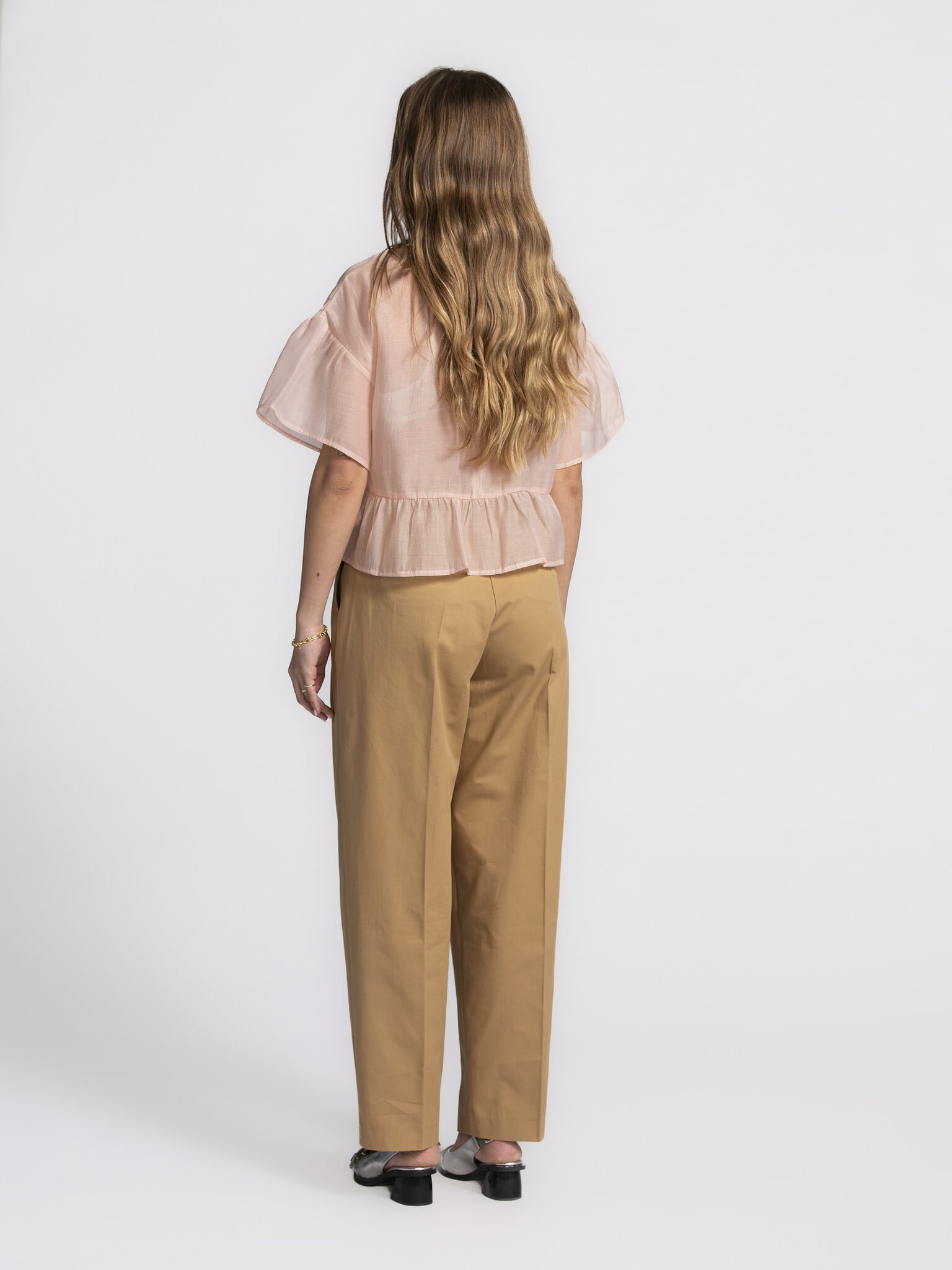 Edited Ruffled blouse Tuala 4. Blushing beauty! This delicate soft pink top brings a romantic touch to your wardrobe. The...
