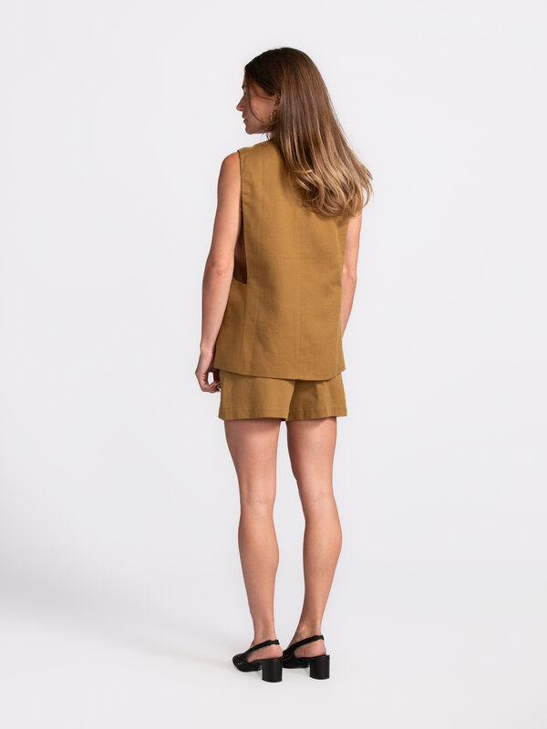 Edited Sleeveless vest Willow 5. Chic & sleeveless -  This sleeveless camel vest is a stylish essential with a cool edge....