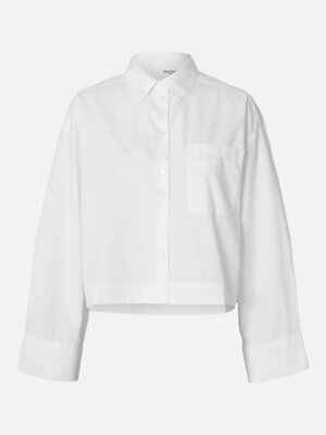 Chemise Astha. Cropped elegance. Cette chemise blanche courte et ample allie simplicité intemporelle et touche contempora...