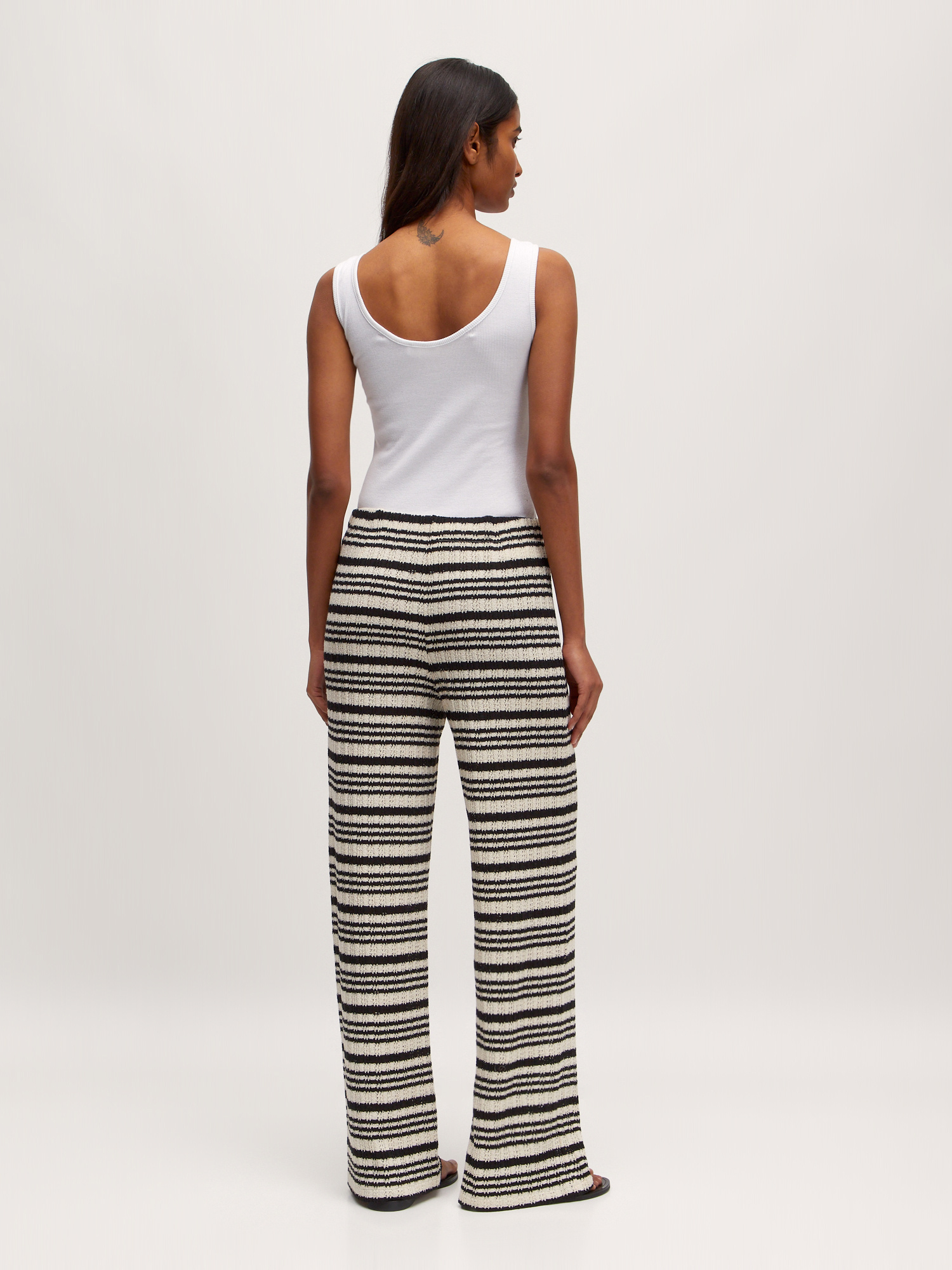 Edited Striped trousers Finn 5. A touch of seventies. These breezy black-and-white striped trousers bring retro flair. Wi...