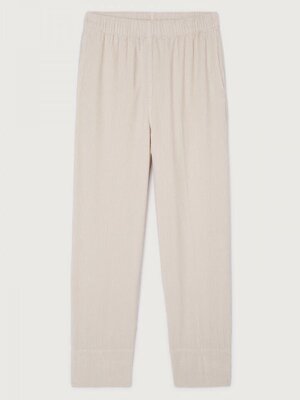 Pantalon Padow. Effortless en écru. Ce pantalon en velours côtelé à taille haute et coupe ample allie confort et style. S...