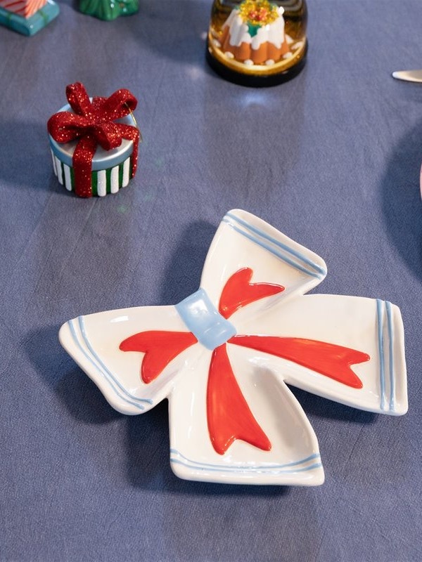 &klevering Plate Ribbon 2. This off-white bow-shaped plate adds a playful, cheerful touch to your table. Each hand-painte...