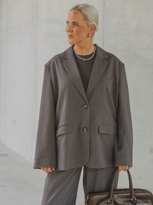 Blazer Momo. Pinstripe power. Ce blazer gris foncé à fines rayures apporte une touche cool à toutes vos tenues grâce à sa...
