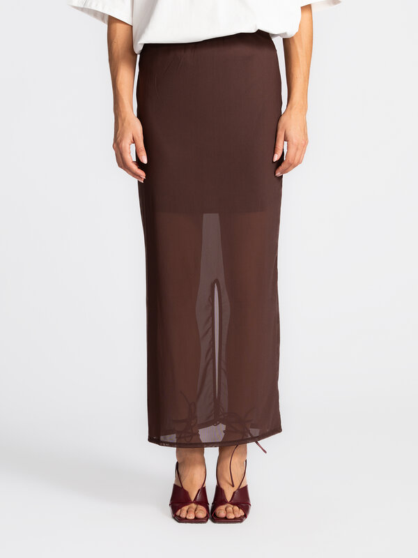 Edited Sheer mesh skirt Ludwine 1. This brown mesh skirt stands out with its semi-sheer fabric and refined finish. Subtle...