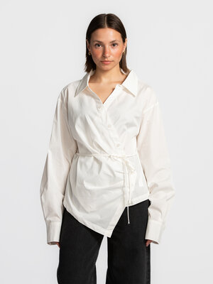 Blouse portefeuille Lillith. La blouse Lillith associe un style chemise classique à une coupe portefeuille moderne. La ma...