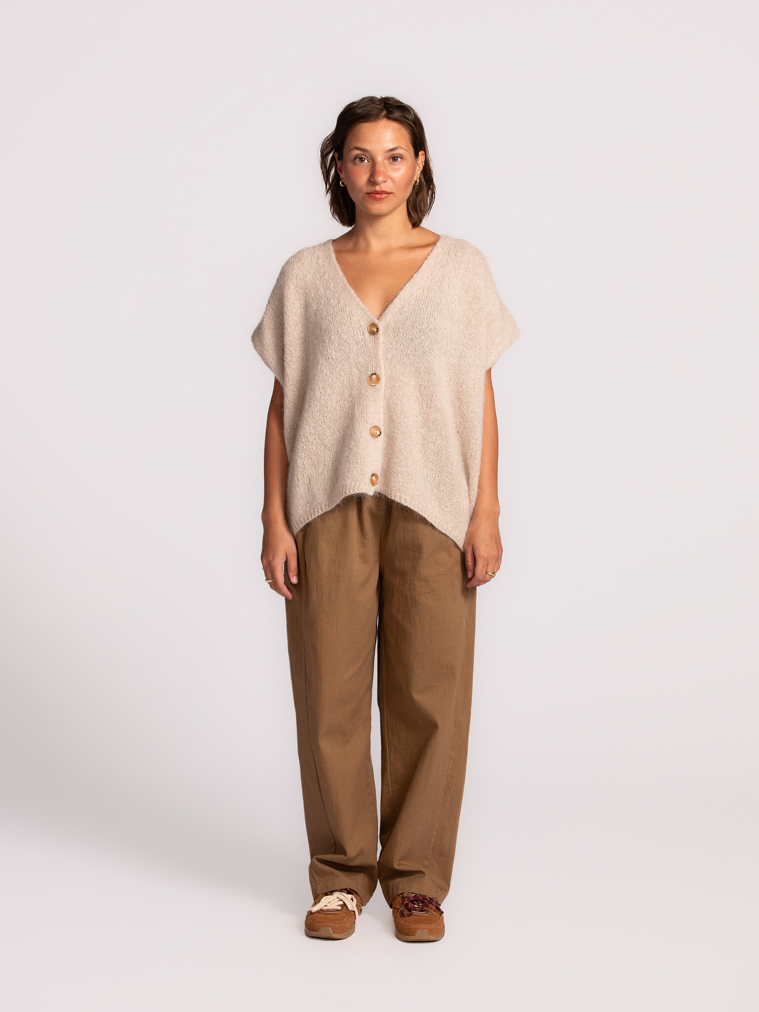 Le Marais Sleeveless knitted vest Live 3. Off-white, the color of infinite styling options. This cardigan not only goes w...