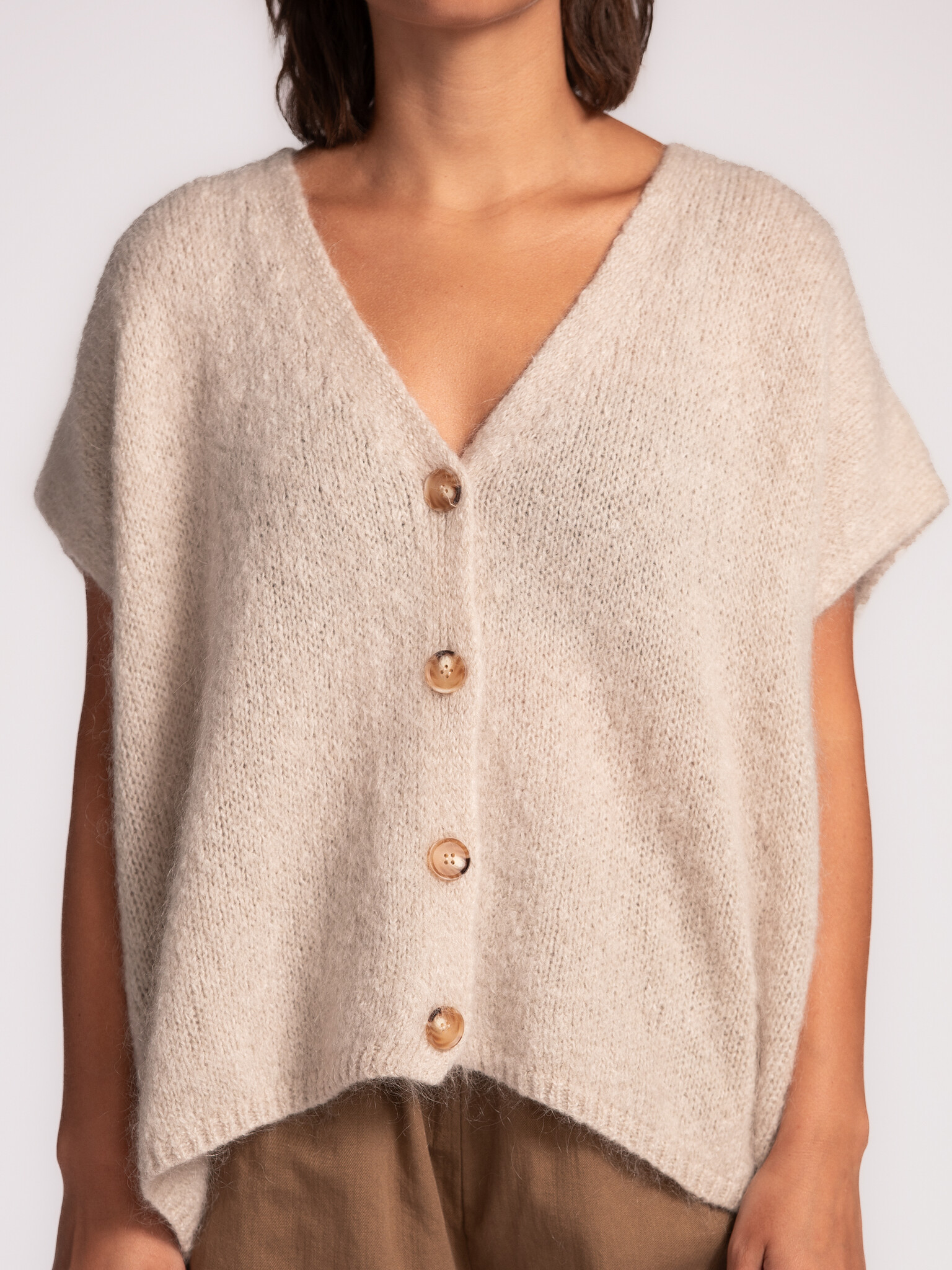 Le Marais Sleeveless knitted vest Live 4. Off-white, the color of infinite styling options. This cardigan not only goes w...
