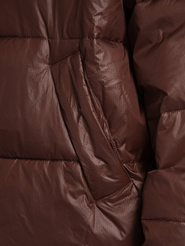 MBYM Pufferjas Seraphina 6. Autumn brown. Deze donkerbruine donsjas combineert warmte en comfort met een coole vibe. De z...