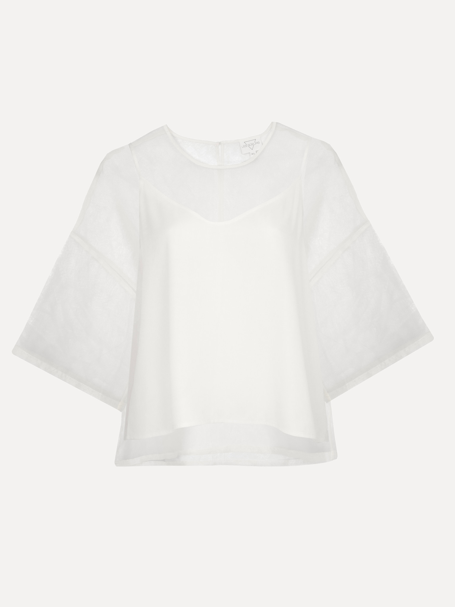 Les Soeurs Top organza Antonio 7. Du blanc, mais épicé! Oubliez la blouse blanche ordinaire, car ce top apporte de l'air ...