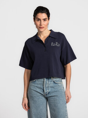 Polo Swans. Classique avec une touche ludique. Cette polo tricotée avec une broderie swan subtile offre une allure décont...