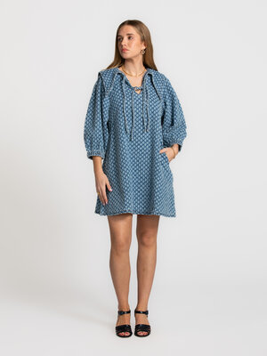 Denim dress. Charming and modern at once. A dress with personality. The oversized collar and bow detail add character, wh...