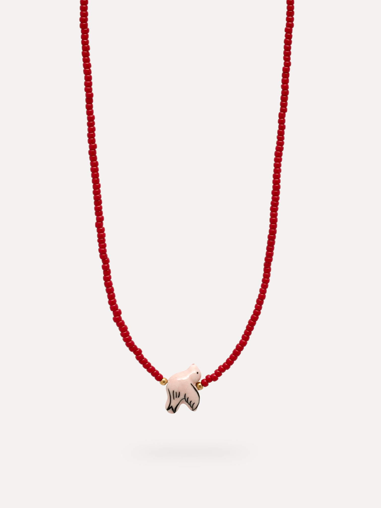 Les Soeurs necklace Aurora 1. Playful, yet full of character. This necklace with fine red beads feels light and summery, ...
