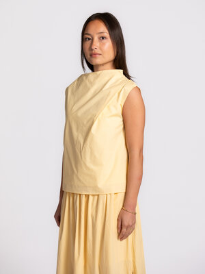 Top Delia. Soft, sunlit, and effortlessly chic. This top pairs a gentle hue with a refined asymmetric cut for a look that...