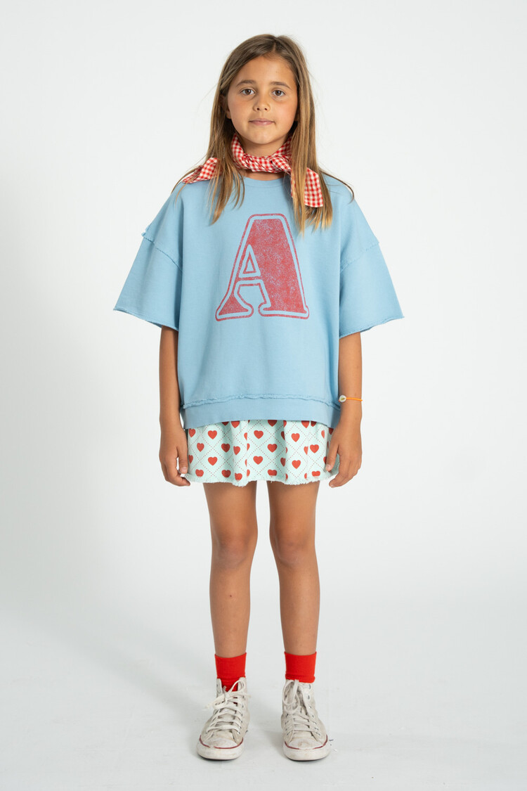 Piupiuchick short skirt | light blue w/ red hearts allover