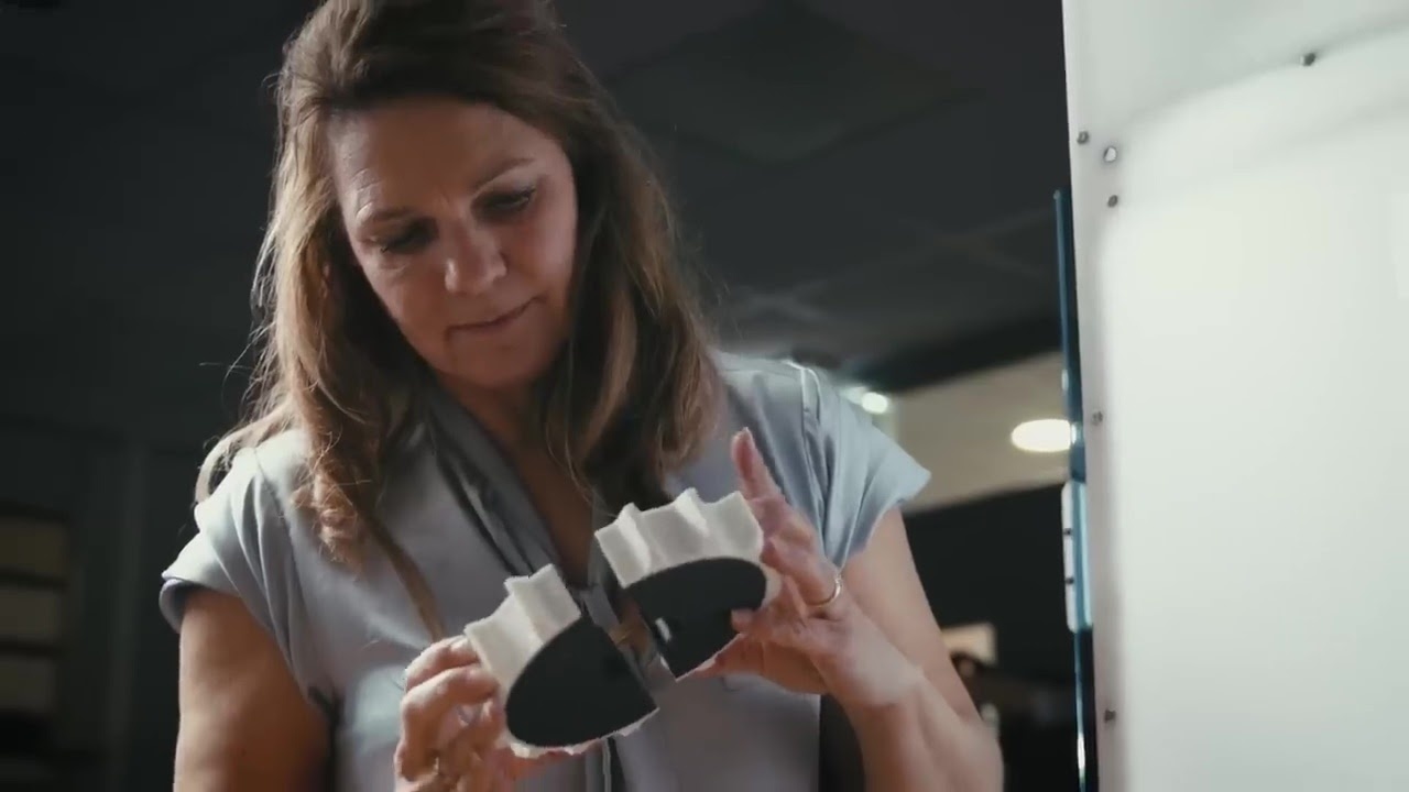 Woman inspecting a 3D printed piece