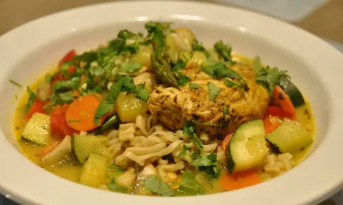 Fresh Delhi Curry soup with noodles and chicken in the wok