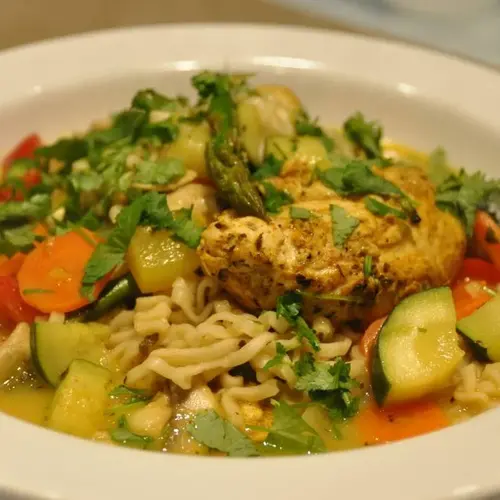 Fresh Delhi Curry soup with noodles and chicken in the wok