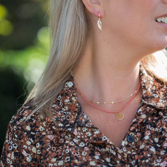 Biba Goud oorrring met vleugel en zwarte steentjes