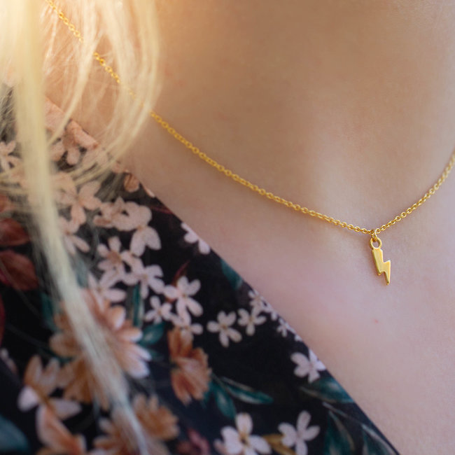 Goud ketting van Karma met bliksem