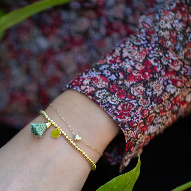 Goud armbandje hartje of kralenbandje kwastje