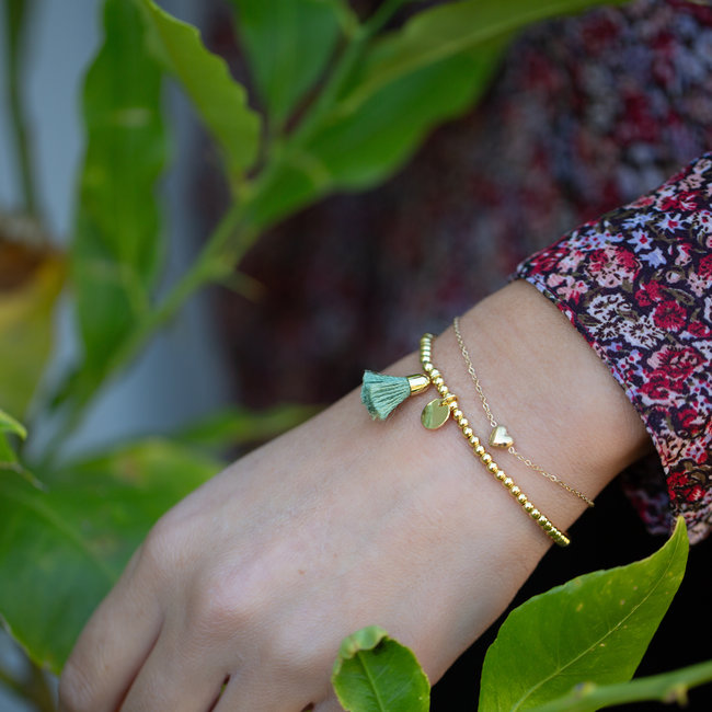 Goud armbandje hartje of kralenbandje kwastje